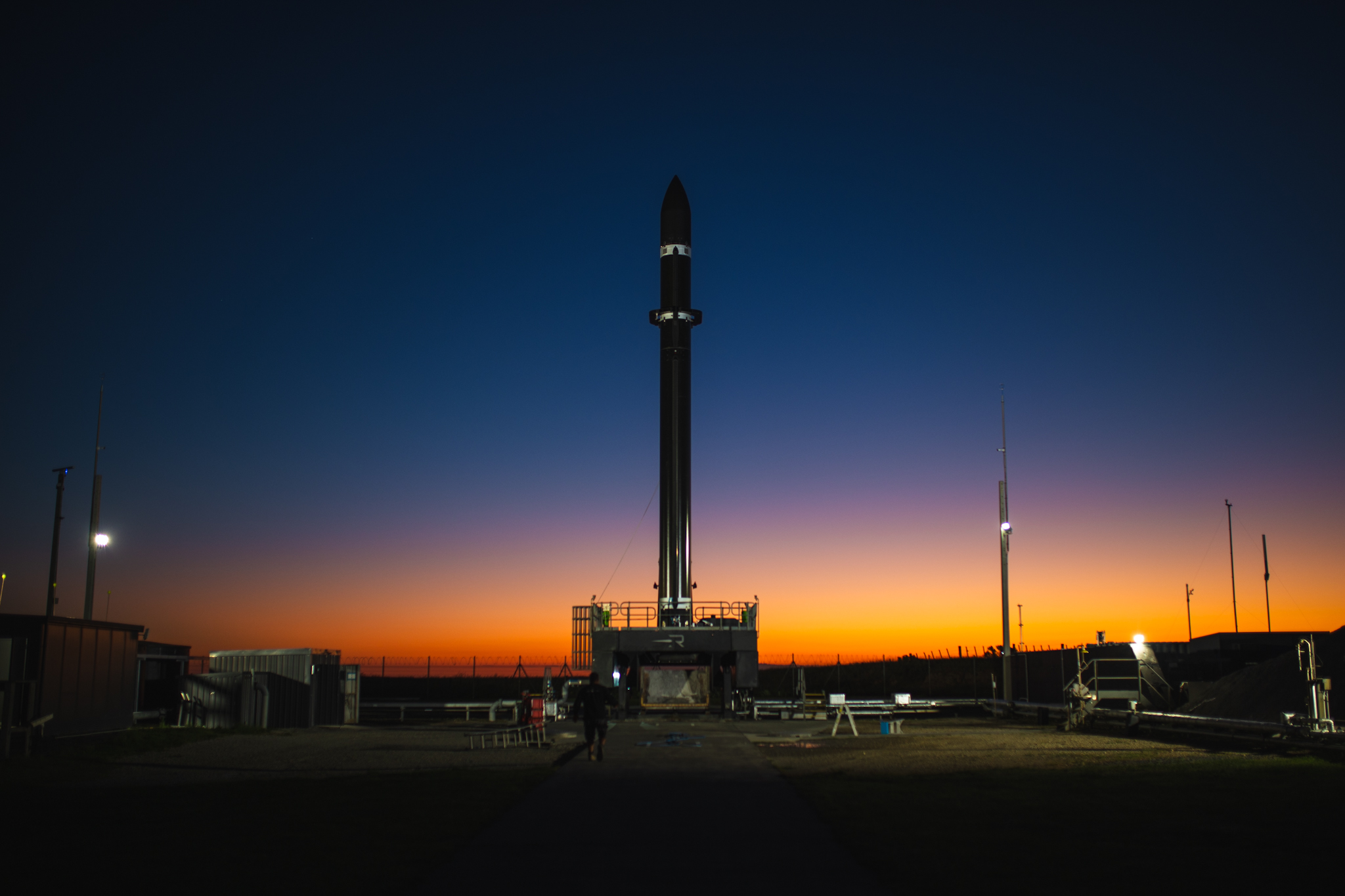 Rocket Lab launch vehicle on the pad at sunset.