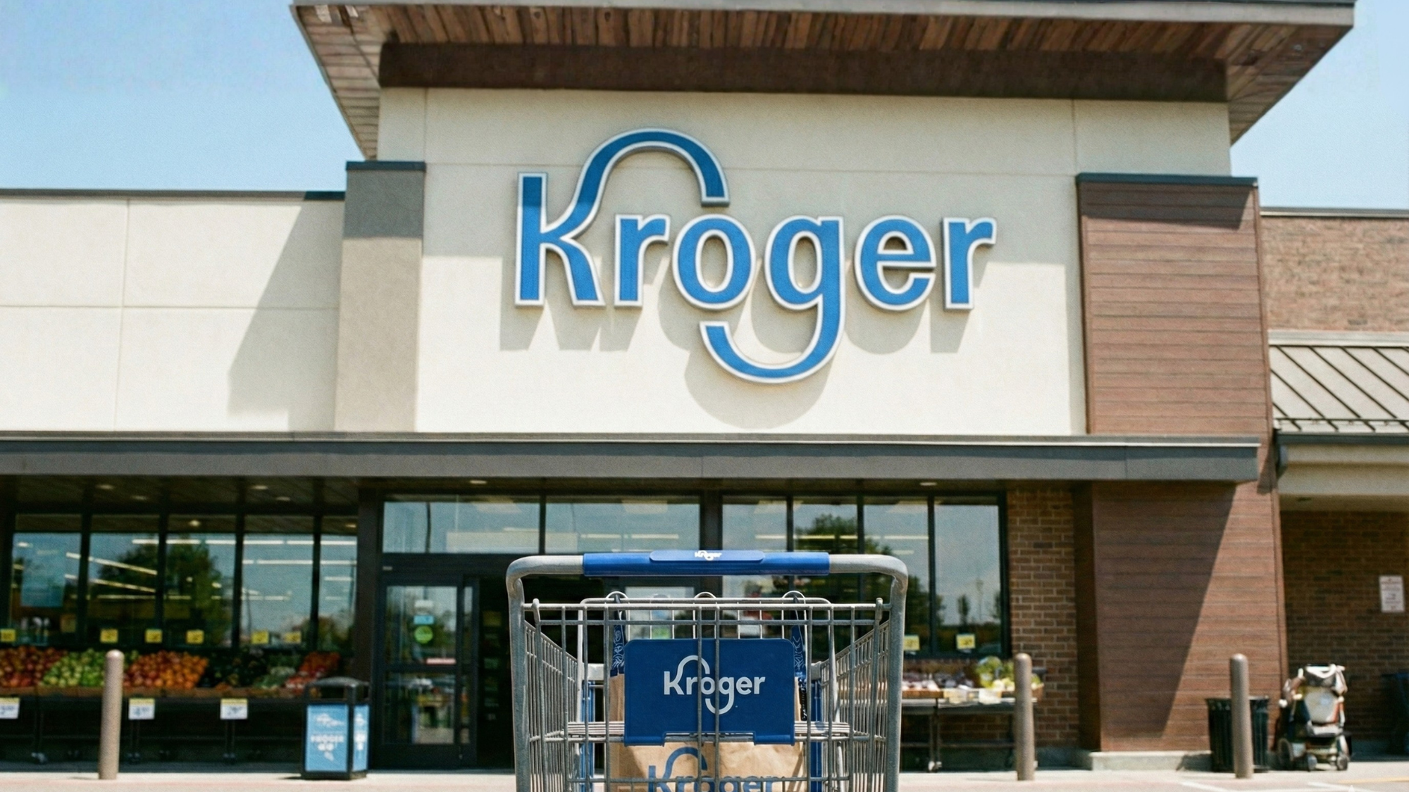 Kroger storefront, with a cart of groceries in the foreground. 