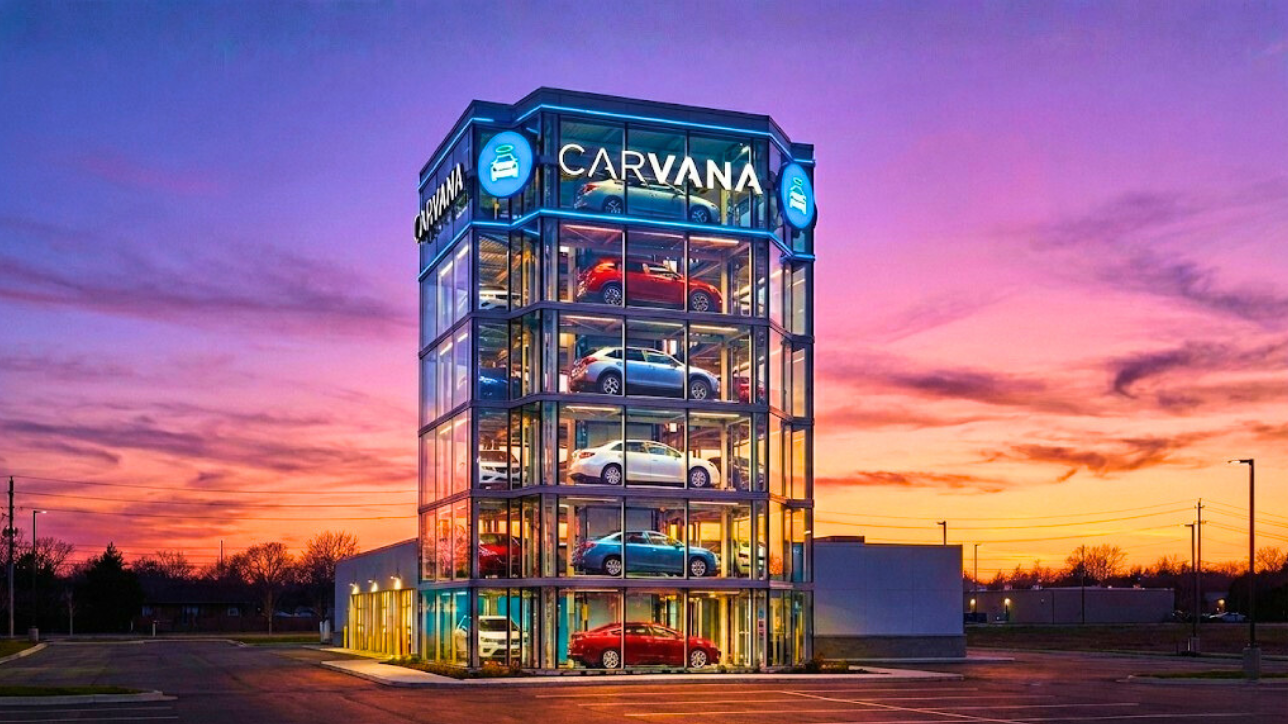 Carvana car vending machine tower at sunset, highlighting online used-car sales growth and CVNA stock.