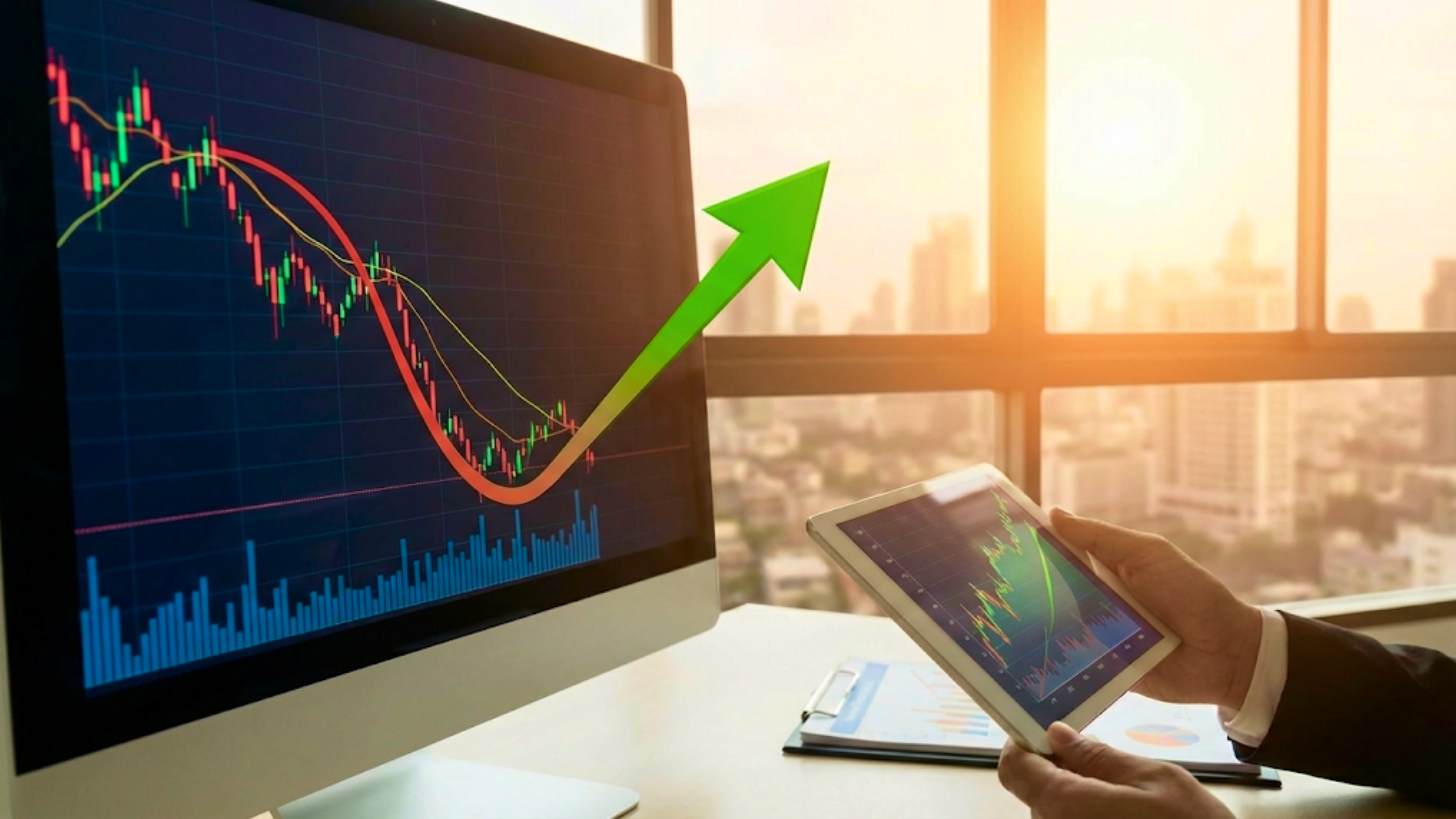 Trader views candlestick chart on monitor with green up arrow, signaling stock rebound amid market optimism.