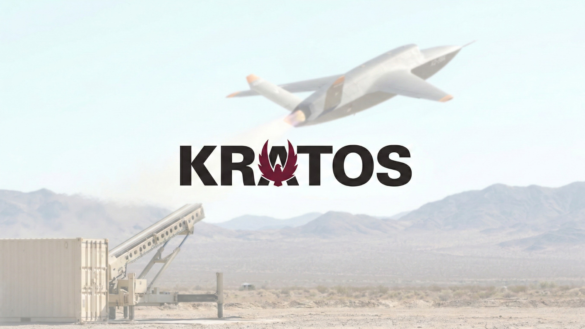 Kratos logo over desert missile launcher and unmanned drone flying above mountain test range.