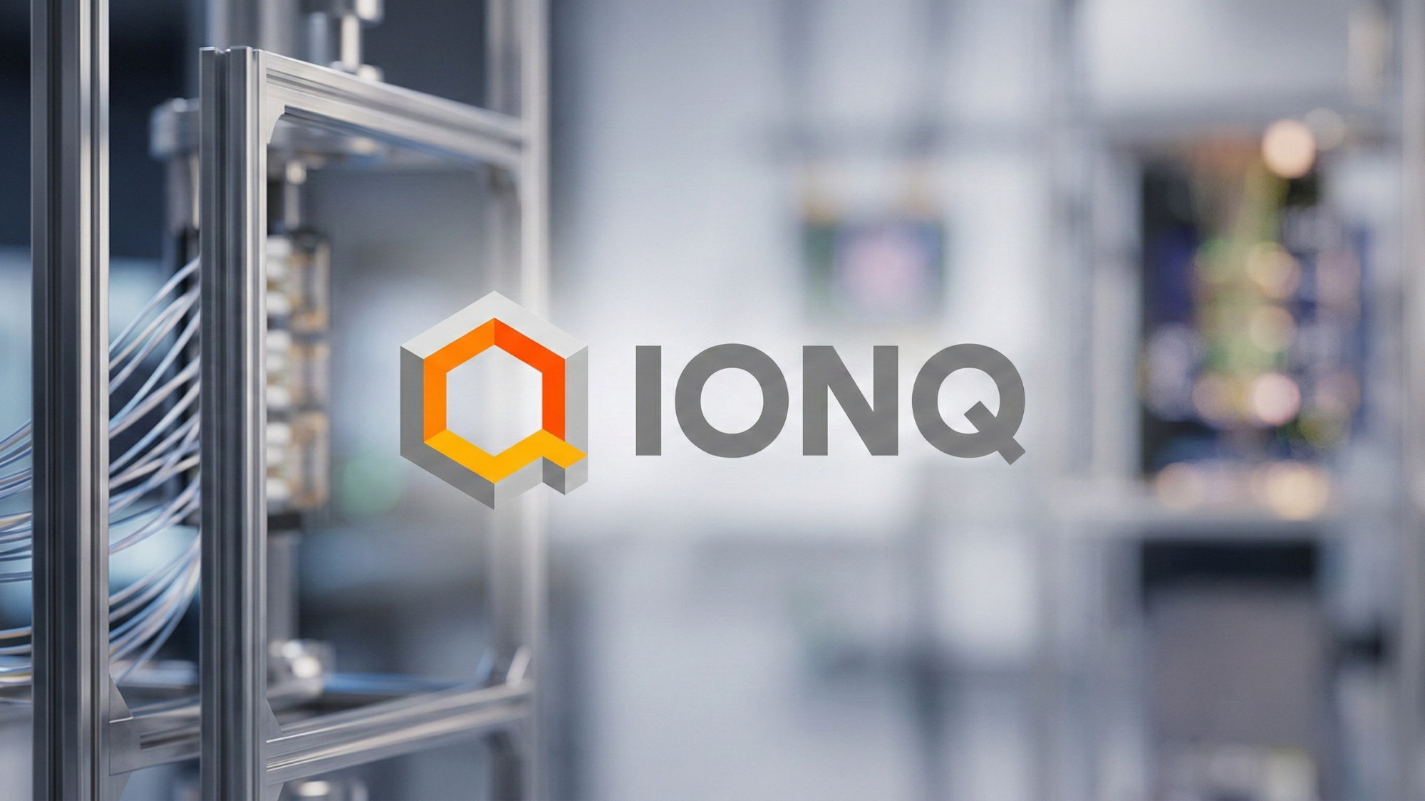 IonQ logo displayed over a blurred high-tech lab setting with metal framing and bundled cables in the foreground.