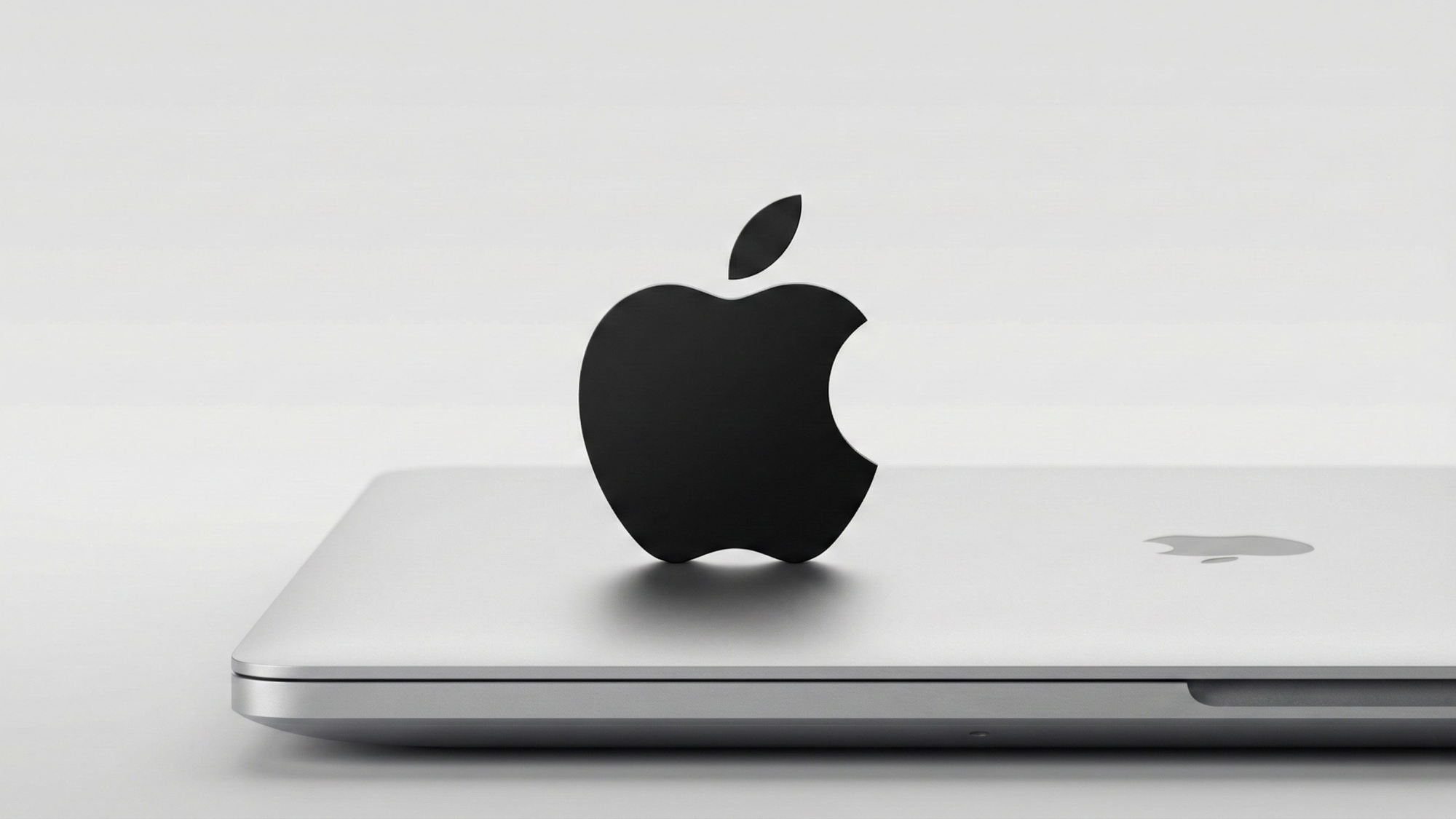 Apple logo on a MacBook underscores new low-cost device launches aimed at boosting market share.