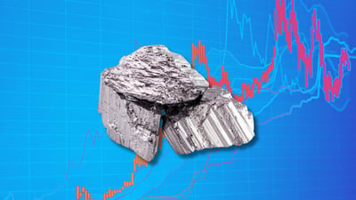 Close-up of rare earth metal sample over stock chart, symbolizing USA Rare Earth volatility and market movement.