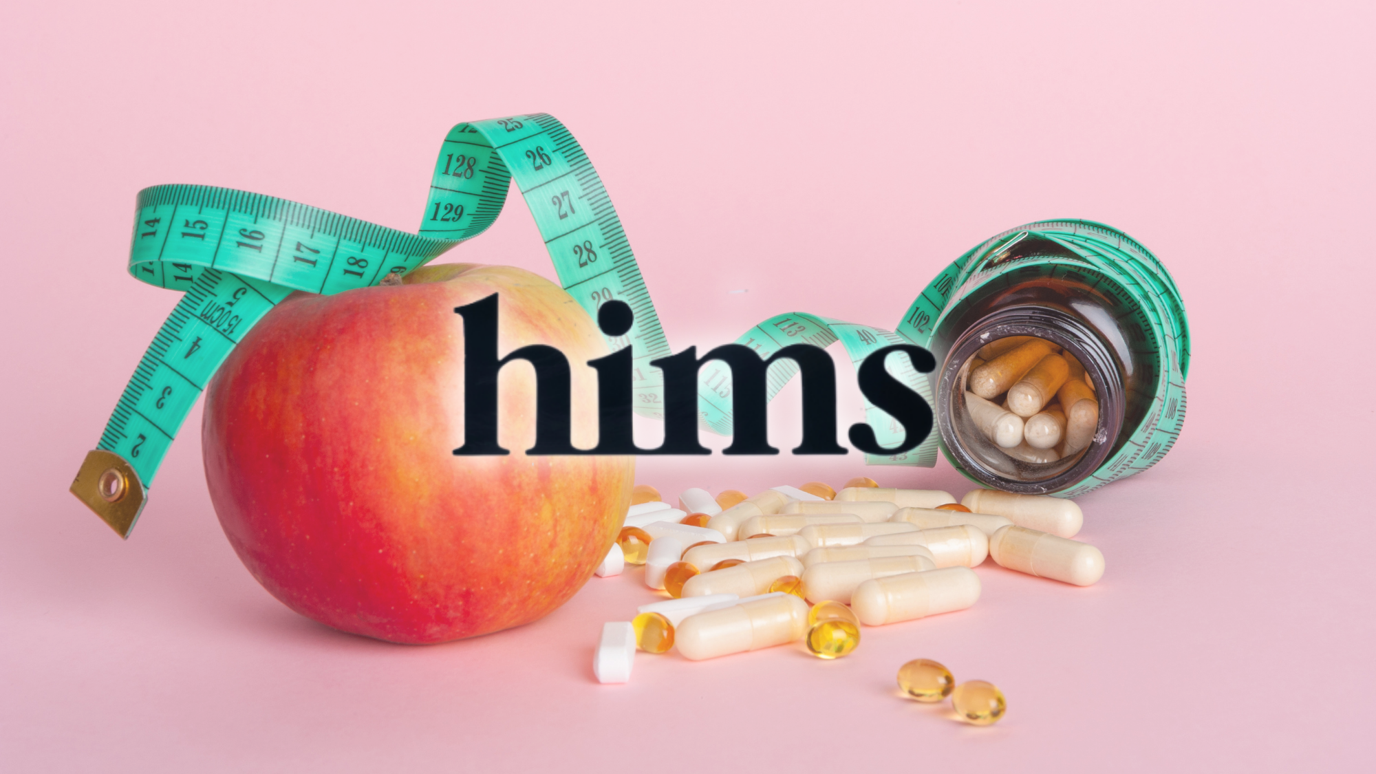 Hims logo overlaid on an apple, measuring tape, and assorted supplement capsules on a pink background.