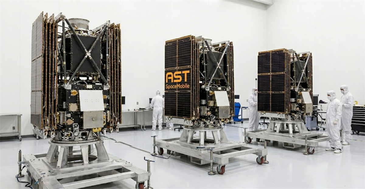 AST SpaceMobile Bluebird satellites displayed in a clean room facility with technicians in white suits nearby.