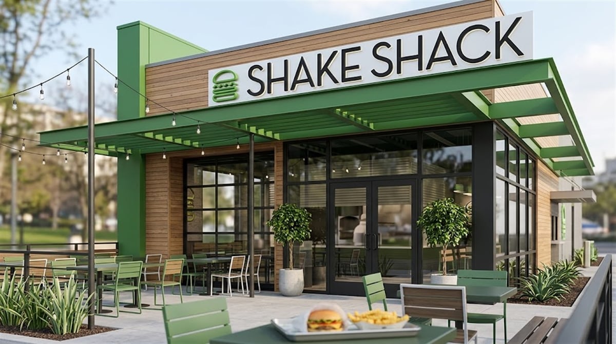 Exterior rendering of a Shake Shack restaurant location with outdoor patio seating and green branding.