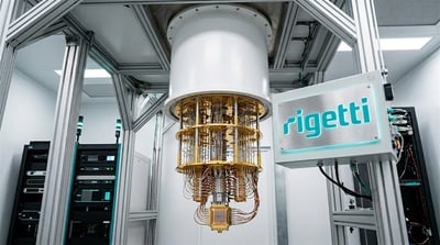 Rigetti Computing quantum processor suspended from a cylindrical dilution refrigerator unit in a lab setting.