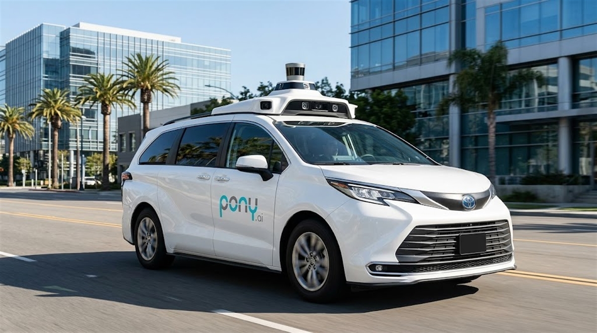 A Pony.ai autonomous vehicle, a white Toyota Sienna minivan equipped with rooftop sensors, drives on a city street.