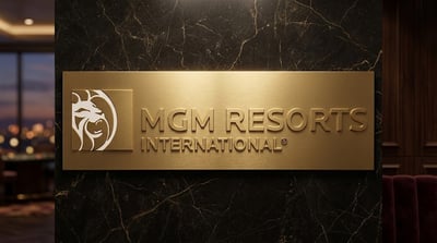 MGM Resorts International logo on a gold placard mounted on a dark marble wall.