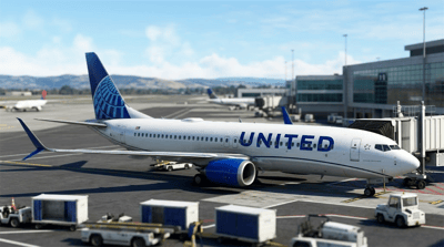 A United Airlines passenger jet sits on the tarmac at an airport terminal.