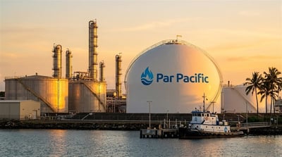 Par Pacific refinery and storage tanks at a waterfront facility photographed at sunset.