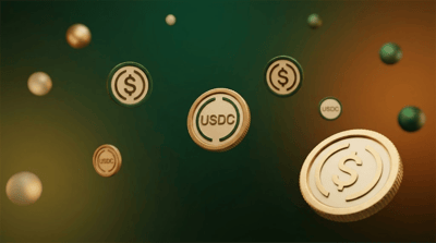 Multiple USDC stablecoin tokens floating against a green and amber gradient background.
