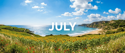 Coastal landscape in July featuring a sunflower field, sandy beach, and blue ocean under a partly cloudy sky.