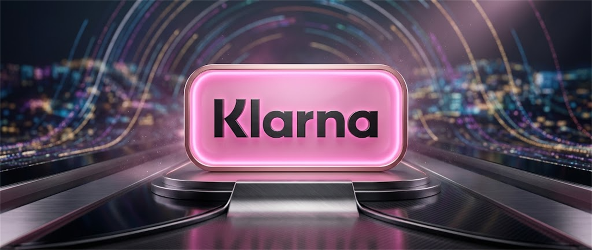 Klarna logo displayed on an illuminated pink sign against a futuristic cityscape backdrop.
