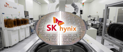 A semiconductor wafer with the SK hynix logo displayed inside a manufacturing fabrication facility.