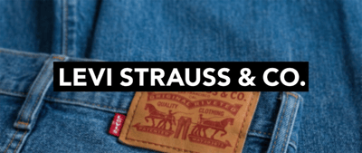 Close-up of denim jeans with a leather patch and back pocket, overlaid with the Levi Strauss & Co. name.