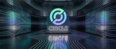 Circle logo illuminated on a display screen in a dark room with glowing teal and purple light lines.