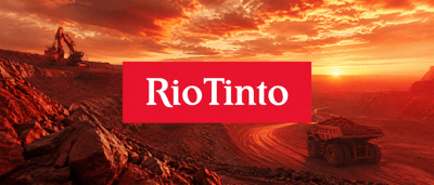 Rio Tinto logo displayed over a mining site with excavators and a haul truck at sunset.
