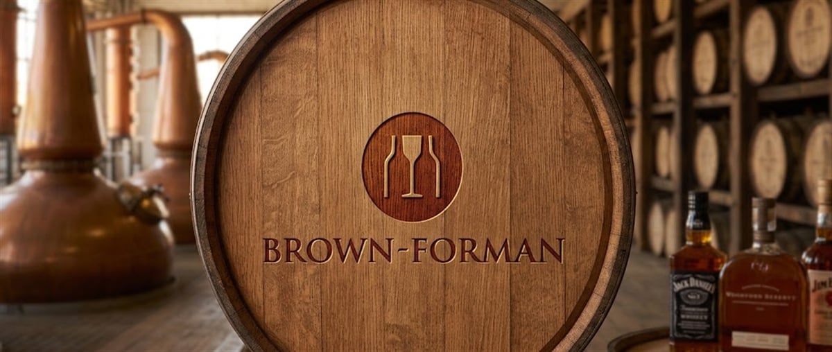 Brown-Forman logo engraved on a wooden barrel, with copper distillery stills and whiskey bottles in the background.