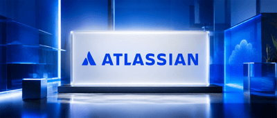 Atlassian logo displayed on an illuminated glass panel in a blue-lit setting with a cloud icon in the background.