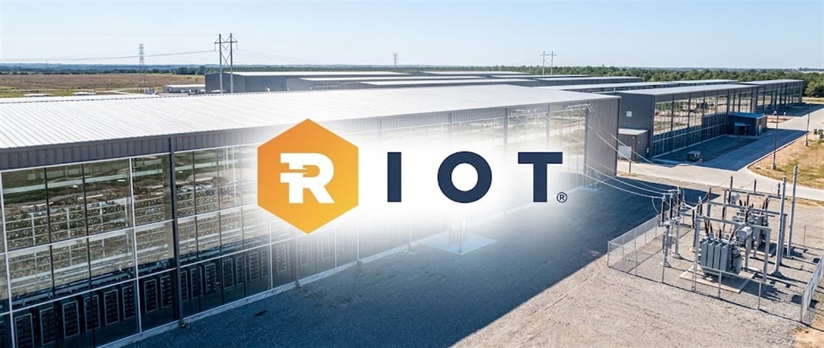 Riot Platforms logo overlaid on an aerial view of a large data center facility with adjacent electrical substation.