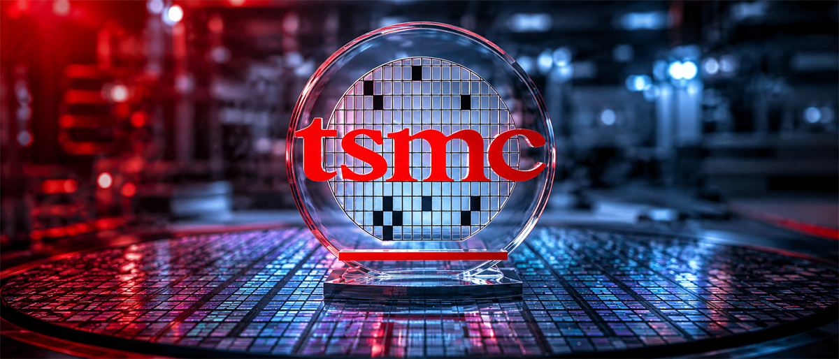 TSMC logo displayed on a glass semiconductor wafer sculpture resting atop a silicon wafer surface.