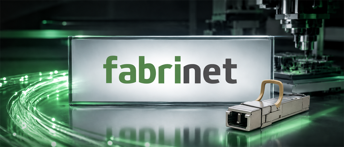 Illuminated Fabrinet logo sign beside a fiber-optic transceiver module with green light strands and manufacturing equipment in background.