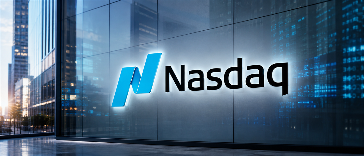 Illuminated Nasdaq logo displayed on a glass building facade, with city skyscrapers reflected around it.