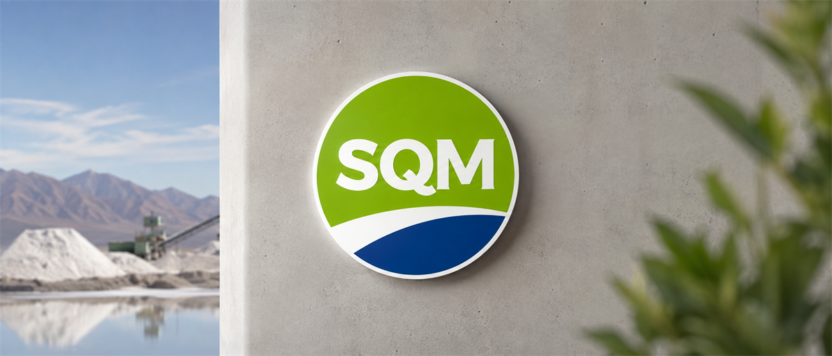 SQM logo displayed on a concrete wall, with a mining or evaporation pond site visible in the background.