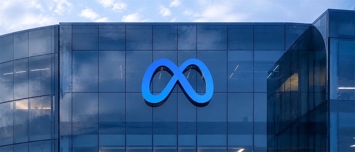 Meta's blue infinity logo displayed on the glass facade of a corporate office building.
