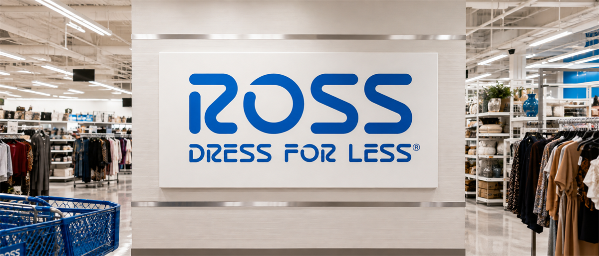 Ross Dress for Less sign displayed on a wall inside a retail store, with clothing racks and shopping carts nearby.