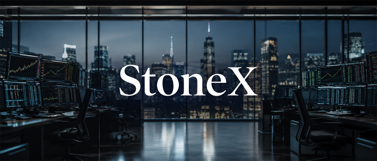 StoneX logo displayed over a trading office with multiple stock chart monitors and a city skyline view.