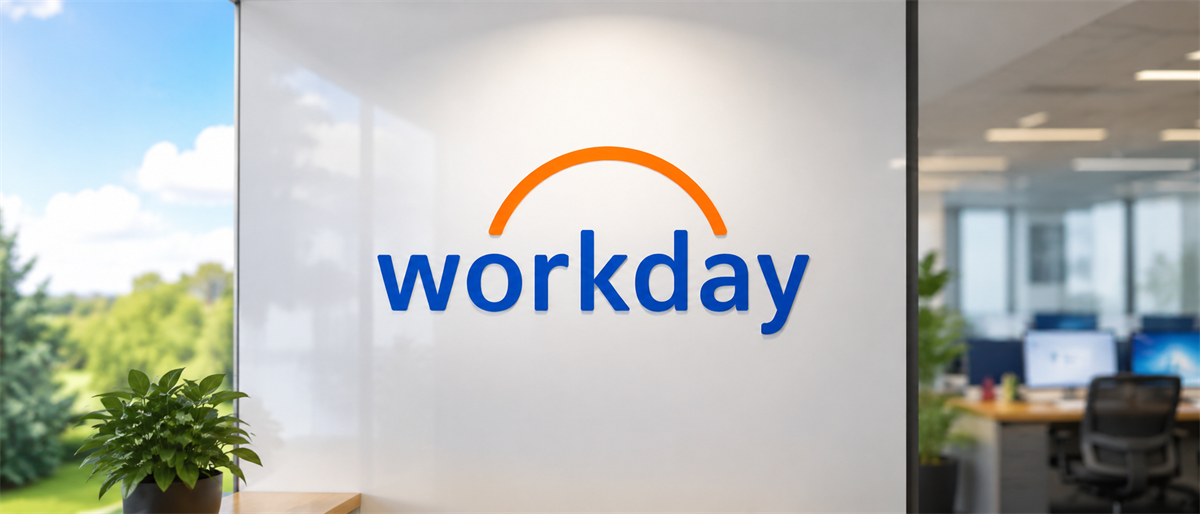 Workday logo displayed on an office wall, with desks and computer monitors visible in the background.