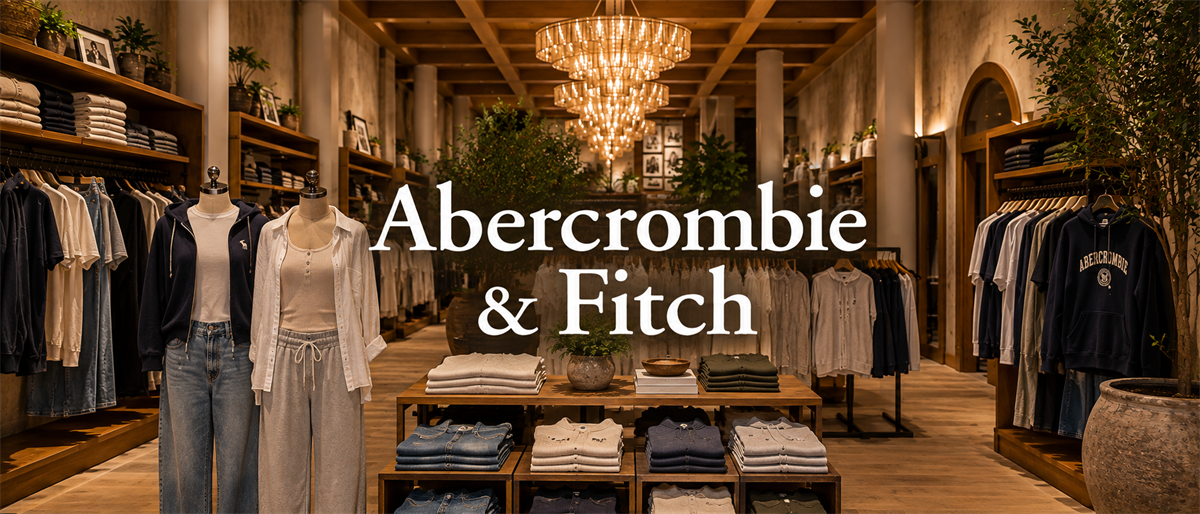 Interior of an Abercrombie & Fitch store with clothing displays, chandeliers, and the company name overlaid.