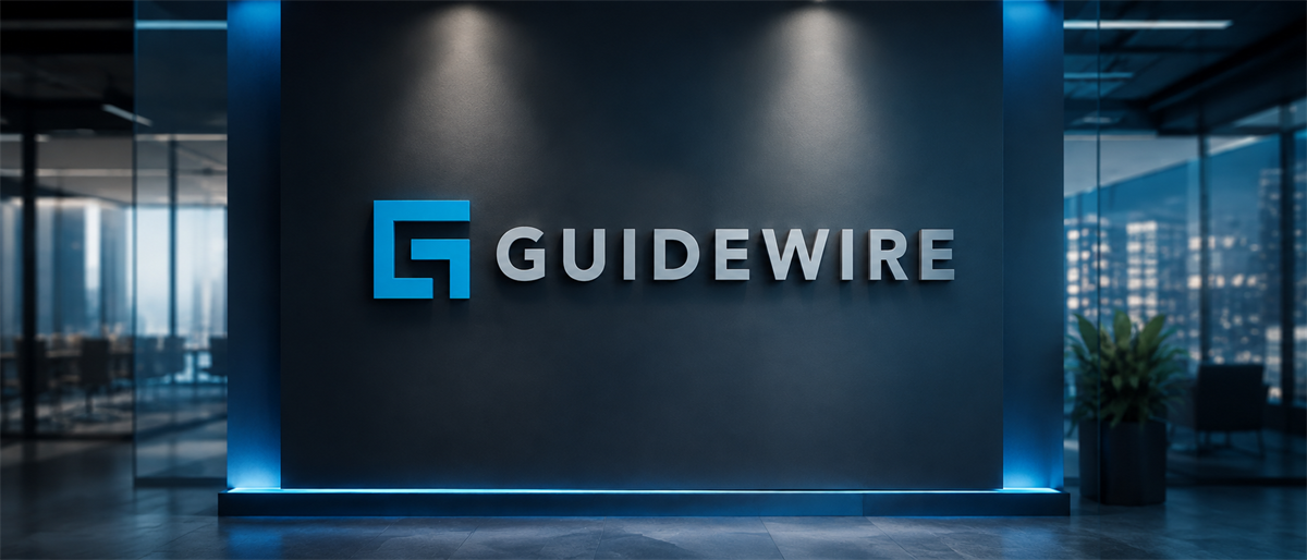 Guidewire logo displayed on a lit wall in a modern office lobby setting.