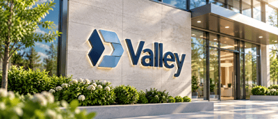 Valley National Bancorp logo and sign displayed on an exterior building wall near a glass entrance.
