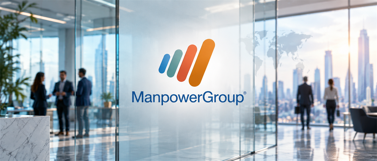 ManpowerGroup logo displayed on glass office partition with blurred professionals and city skyline in background.