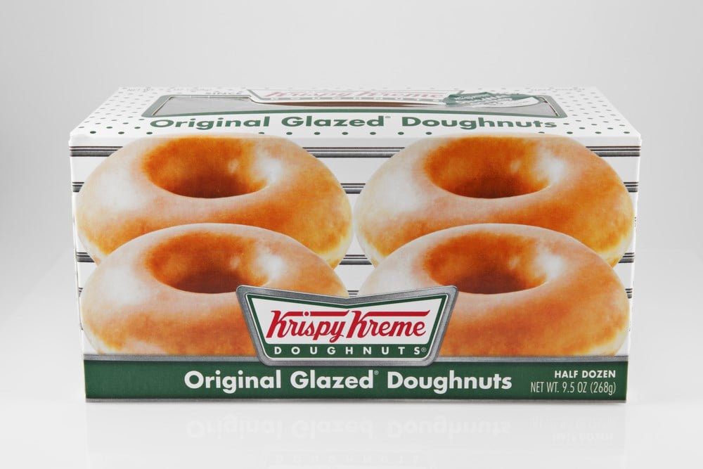 A studio shot of a box of 6 Krispy Kreme Original Glazed Doughnuts.