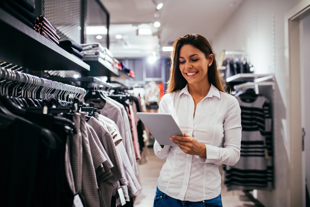 Should you invest in retail? Overview of the best retail stocks to invest in and woman in retail store.