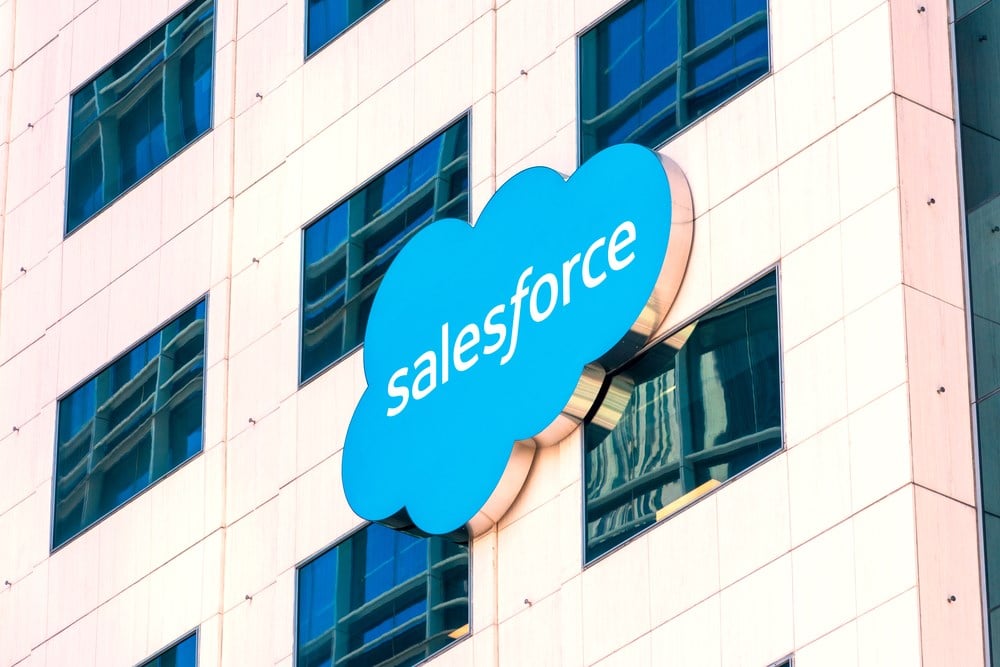 Salesforce cloud logo on modern facade: What is the Salesforce stock forecast? Learn more.