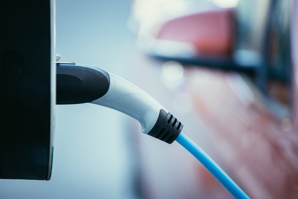 Electric car recharging with charge cable and plug leading to charge point