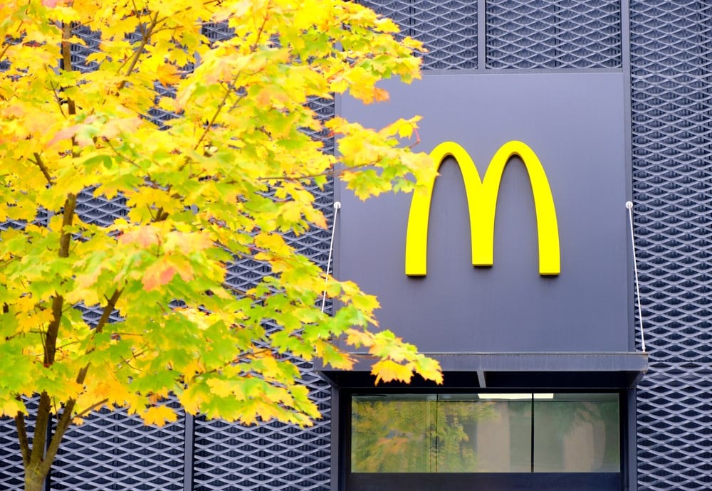 Arcos Dorados means "Golden Arches" in Spanish. McDonald's restaurant with tree in front of it. Learn more about Arcos Dorados stock.