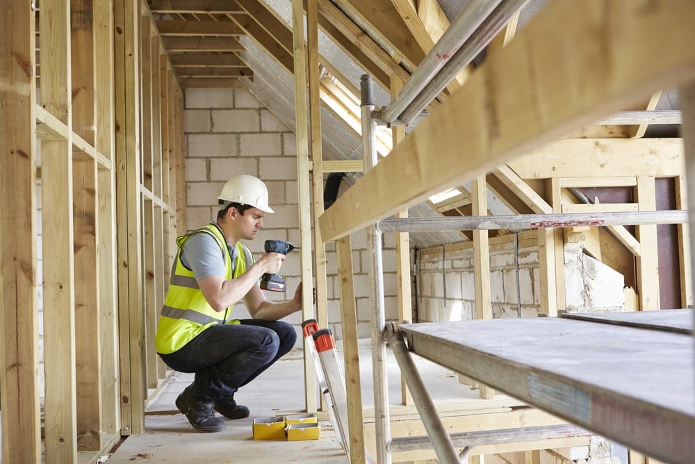 Can you benefit from homebuilder stocks? Image of a construction worker working on a home