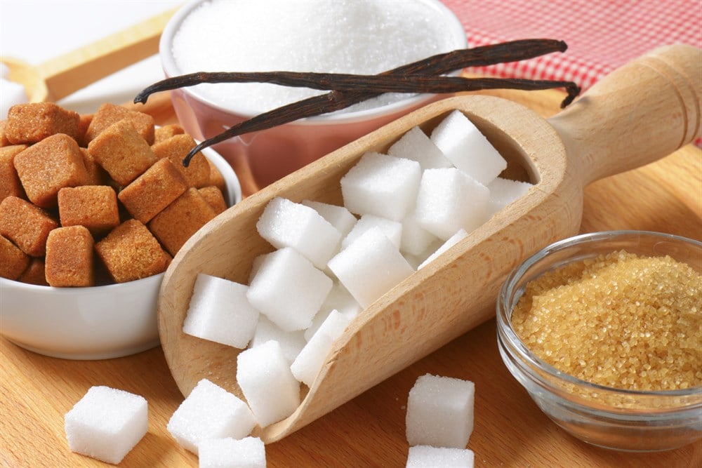 Still life of various types of sugar; learn more about sugar stocks to invest in on MarketBeat