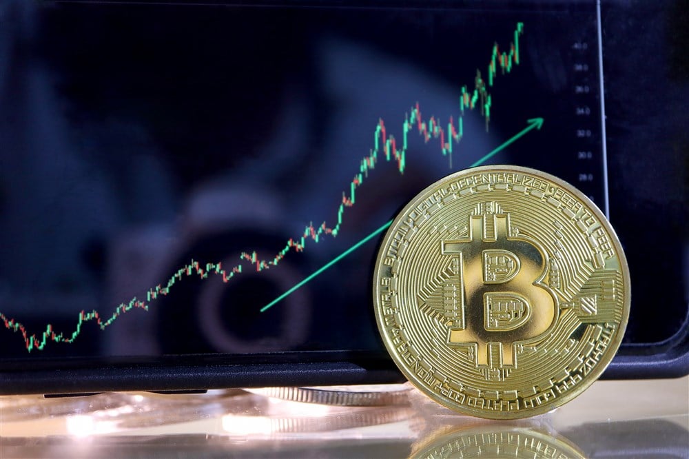 Image of Bitcoin with stock graph in background