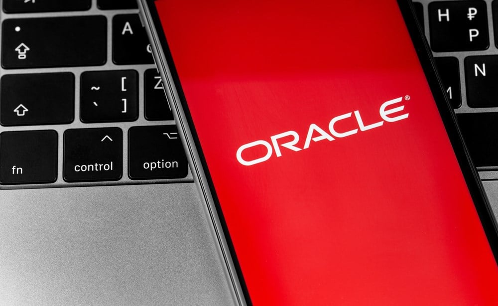 Oracle logo app on the red screen smartphone with notebook closeup. Oracle is an American multinational computer technology corporation. Moscow, Russia - September 25, 2020