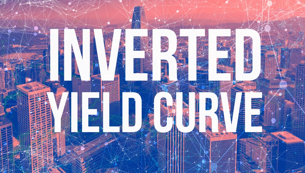 Image of a city with the words "inverted yield curve": what is the inverted yield curve meaning? Learn more.