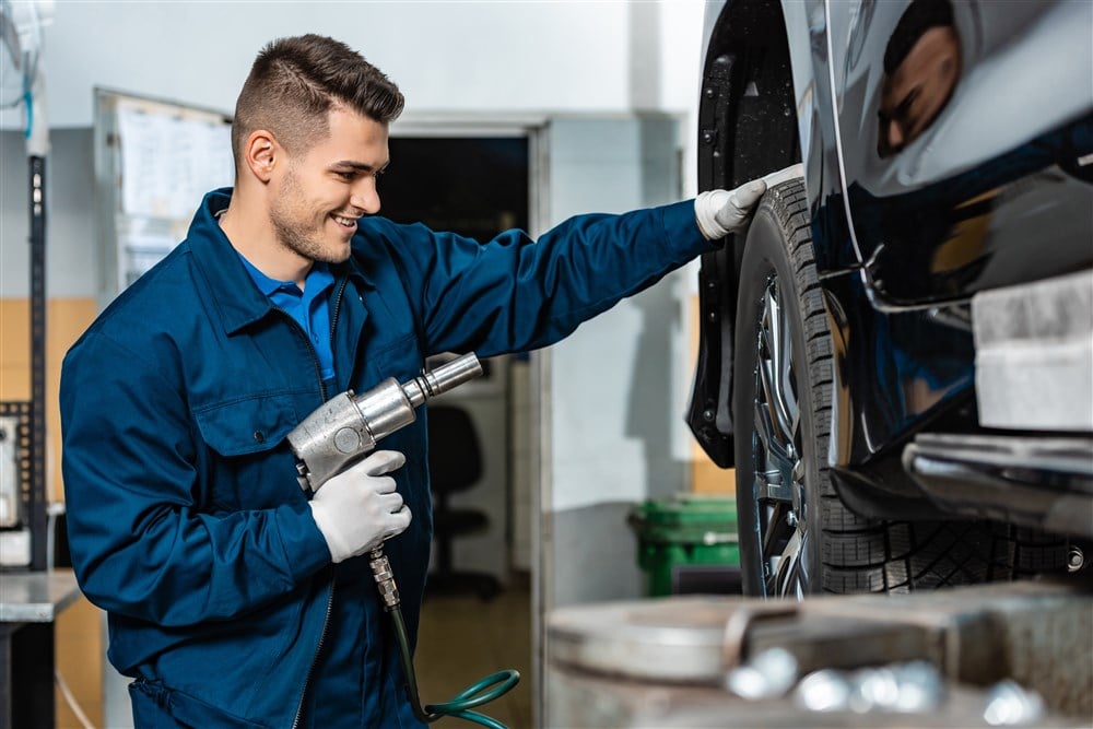 auto repairman with tire