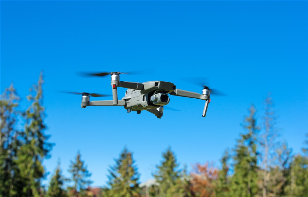 drone copter flying in clear blue sky